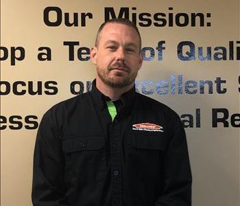 Male SERVPRO Employee Standing in front of a wall