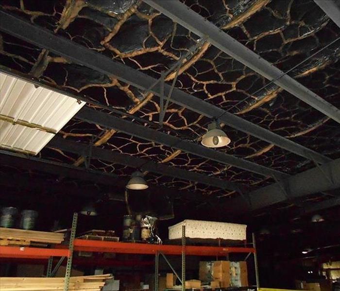 Fire damage to the interior ceiling of a commercial building